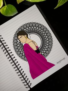 a notebook with a drawing of a woman in a pink dress