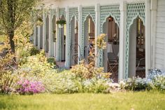 a garden with flowers and plants in front of a house