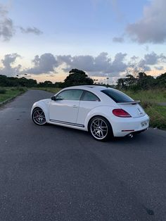 a white car parked on the side of a road