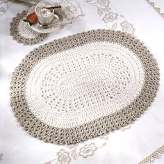 the table cloth is white and has a crochet design on it