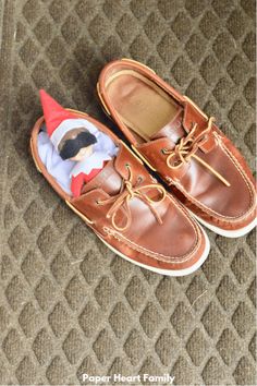 a pair of brown shoes with a stuffed animal in the soles on top of them