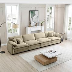 a living room filled with furniture and a white rug on top of a hard wood floor