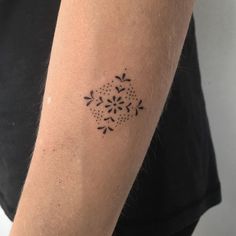 a woman's arm with a tattoo on it that has an intricate design in the middle