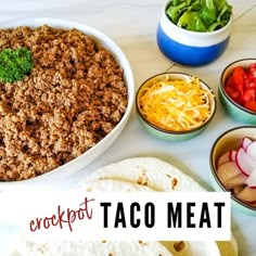 a table topped with taco meat and other food items next to bowls of vegetables