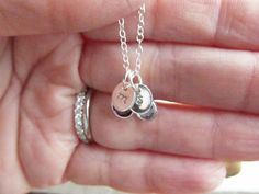 "\"Sterling Silver Tiny Treasure 3\" This necklace features very petite personalized charms; Swarovski birthstone crystal(s), and tiny sterling silver oval tag charm(s) hand metal stamped with your choice of initial. They are attached to a fine sterling silver chain which has a lobster clasp closure. Both charms are included; if you need 2 initials and 2 birthstones, select \"2\" from the option box, \"3\" for 3 initials and 3 birthstones, and so on. A lovely personalized gift for those who pref Tiny Sterling Silver Charm Necklace For Anniversary, Tiny Sterling Silver Charm Necklaces For Anniversary, Oval Silver Birthstone Necklace Gift, Silver Oval Birthstone Necklace Gift, Dainty Sterling Silver Birthstone Charms, Sterling Silver Initials Charms For Gifts, Sterling Silver Dainty Charms For Anniversary, Dainty Sterling Silver Charms For Anniversary, Oval Charm Necklaces As Gift