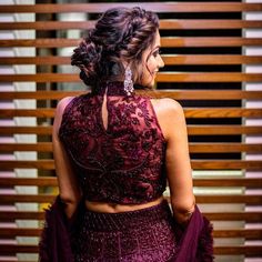 the back of a woman's dress in front of wooden slats