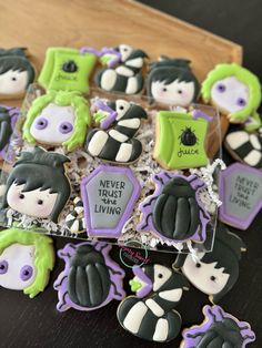 decorated cookies in the shape of witches on a wooden tray with words never trust living