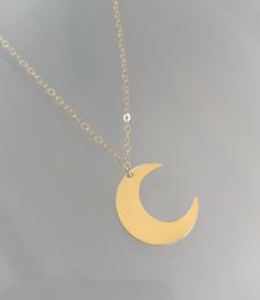 "This beautiful moon and star necklace will shine bright any time of day! The large crescent moon hangs from a sparkly chain with two stars above. The moon is approximately 40mm and the tiny stars are 6mm. The necklace comes in your choice of sterling silver or gold filled and can be hammered or left smooth. Shown in a 30\" length in gold with smooth finish. *Also available in our tiny and medium versions as seen in the last two photos. *If you are unsure of the length you need, or would like to Gold Moon Charm Necklace With Sun And Moon Design, Celestial Gold Charm Necklace With Moon Charm, Gold Moon Charm Celestial Necklace, Gold Moon Charm Necklace, Celestial Style, Gold Moon Charm Necklace In Celestial Style, Gold Moon-shaped Celestial Charm Necklace, Gold Celestial Necklace With Moon Charm, Gold Crescent Moon Charm Necklaces, Gold Moon Charm Jewelry