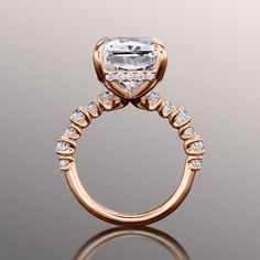 an engagement ring with a large diamond in the center and two rows of diamonds on each side