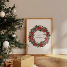 a christmas wreath with poinsettis on it next to presents