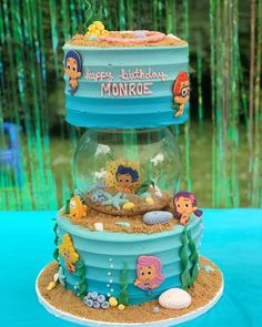 a birthday cake made to look like the little mermaids are in a fish bowl