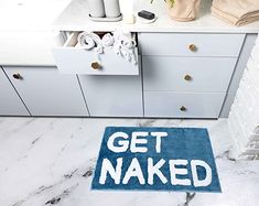 a bathroom rug that says get naked on it