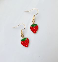 * Strawberry Earrings Fruit Earrings * Strawberry Necklace is available: https://www.etsy.com/listing/1722301802/red-strawberry-fruit-18k-gold-plated *  Earring Wire (Hypoallergenic & Nickel Free)  -18 K Gold Plated  (base: 304 Stainless Steel)  * Earring charm:  Alloy Enamel Pendants, Strawberry Size: about 20.5mm long, 13mm wide, 2mm thick *The color displayed may vary depending on your screen. ✨ Check out my Etsy shop for more handmade products!       https://hannaschoice20.etsy.com 🌟 Follow Cute Drop Earrings For Birthday, Trendy Red Earrings For Birthday, Trendy Red Nickel-free Earrings, Trendy Nickel-free Red Earrings, Birthday Dangle Single Earring, Red Single Earring As Gift, Single Red Earring For Gift, Single Red Earring Gift, Cute Dangle Earrings For Valentine's Day