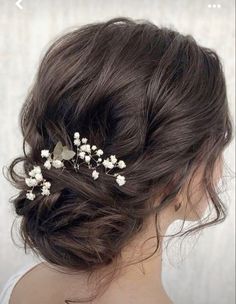 a woman wearing a hair comb with flowers in it