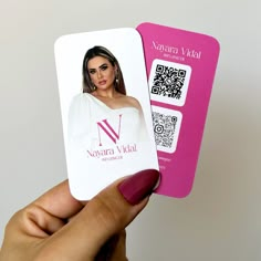 a person holding up a business card with a qr code on the front and side