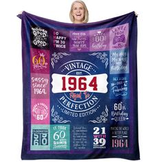 a woman holding up a purple blanket with the words, age and years on it