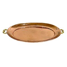 an oval metal tray with gold handles