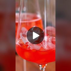 two wine glasses filled with red liquid and ice