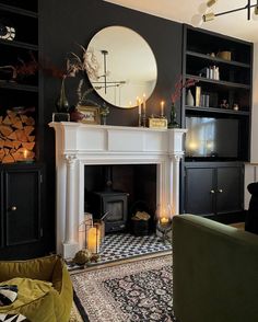 a living room filled with furniture and a fire place in front of a black wall