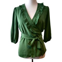 Ann Taylor Womens Size 2 New Flaw Green Ruffle V-Neckline 3/4 Sleeves Wrap Top Top Is Nwt, Has A Few Tiny Spots, On Sleeve, Tie, No Rips, Holes Or Tears, Really Pretty Green Top, Ruffle V-Neck, 3/4 Sleeve W/Elastic Cuff, Wrap Tie Top Dress Form In Photos Is A Medium Form With A Bust Of 34.5" Approximate Measurements While Laying Flat Armpit To Armpit - 18" Length - 23.5" Ruffled 3/4 Sleeve Blouse For Work, Ruffled 3/4 Sleeve Tops For Work, Chic Green Blouse With 3/4 Sleeves, Elegant Green Blouse With 3/4 Sleeves, Chic Green Half-sleeve Blouse, Chic Green Half Sleeve Blouse, Pretty Green, Tie Top, Green Tops