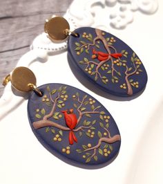 pair of earrings with red bird on tree branch