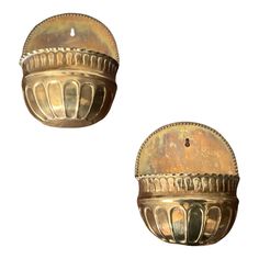 two antique brass door knobs on a white background