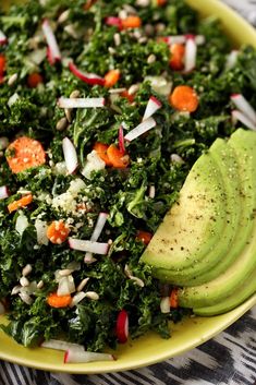 a salad with avocado, carrots and other vegetables