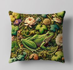 a green frog sitting on top of a lush green leaf covered pillow with flowers and leaves around it