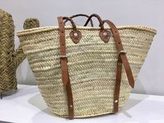 "luxury Straw bag Straw baskets Backpack Market basket with Brown/Tan leather handles Can be carried in the hand or worn on the shoulder Our Baskets are classic French Market Basket. The perfect choice for shopping trips, picnics, days at the beach. Not only, they're eco-friendly, they look great in the home for storing toys or magazines. Handwoven by women in Morocco using palm leaf, and crafted in our workshop, they are both sturdy and flexible. With short leather handles for comfortable carry Basket Backpack, Market Basket Bag, Straw Baskets, Beach Backpack, Storing Toys, French Market Basket, French Baskets, Natural Baskets, Market Basket