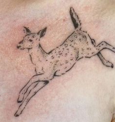 a deer tattoo on the chest is shown in black and grey ink, with an antelope running across it's body