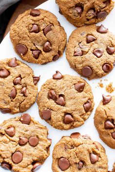 chocolate chip cookies are arranged on a white platter and ready to be eaten for the camera