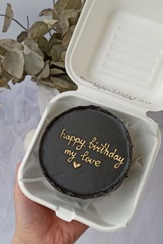 a birthday cake in a box with writing on it