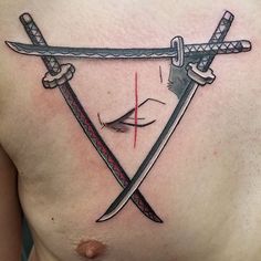 a man's chest with two swords on it, and an eye in the middle