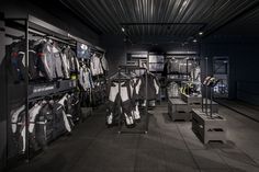 the inside of a clothing store with clothes on display