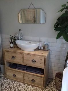 a bathroom with a sink, mirror and bathtub in it's center area