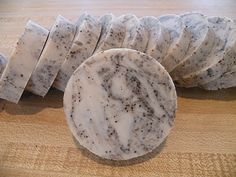 several pieces of white marble sitting on top of a wooden table next to each other