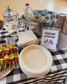 a table topped with lots of food on top of a black and white checkered table cloth