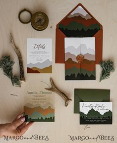 the wedding stationery was designed to match the theme of the mountain scene and forest