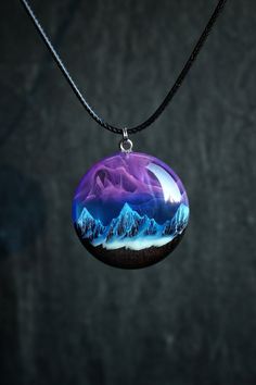 Handmade round Northern lights pendant from black hornbeam wood and epoxy resin with snow mountains inside.  Glow in the dark! D E T A I L S : * Made to order epoxy resin necklace * Materials: black hornbeam wood (impregnated with protective eco oils) and epoxy resin * Available in three sizes: 34mm, 31mm, 28mm. * Shipped in a box for easy gift giving * Each piece is handmade. The wood we use is of high quality and absolutely smooth to the touch. The resin is polished to a mirror finish. N E C K L A C E : * Black waxed cotton cord -- 1.5mm with with stainless steel fittings and lobster clasp The length of the cord can be made to your liking. Standard length 55 centimeters.   I M P O R T A N T :  * It takes up to 2 weeks to make the product after completing the order! C U S T O M and H A N God Crafts, Epoxy Resin Necklace, Edgy Girls, Snow Mountains, Wood Resin Jewelry, Lights Pendant, Stainless Steel Fittings, Unusual Flowers, Cool Swords