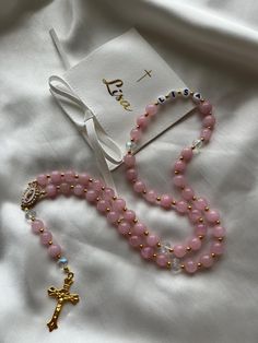 Personalized rosary accompanied by its matching pouch, ideally designed to be offered during the sacraments, birthdays, etc. Elegant Healing Rosary, Personalized White Rosary, Gold Hand-strung Rosary Bracelet As Gift, Pearl Rosary For First Communion, Spiritual Style, Pink Spiritual Hand-strung Rosary Bracelet, Personalized Rosary, Rosary, Charms, Pouch