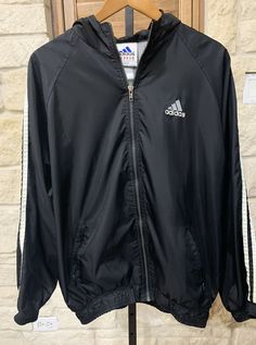 Adidas Men’s Vintage Black Hooded Windbreaker Logo 3 White Stripes Size XL. (R4) Jacket is in great, vintage condition. No odors. No rips or tears. Elastic cuffs and hem. Full zip. Hooded and logo on back. P2P measures 23 inches and back of neck to hem is 27 inches. Shipped USPS First Class Please view photos and feel free to ask questions. Black Adidas Windbreaker For Winter, Adidas Black Windbreaker With Logo, Hooded Three-stripes Windbreaker For Streetwear, Hooded Windbreaker With Three Stripes Branding, Adidas Hooded Windbreaker With Three Stripes, Hooded Streetwear Windbreaker With Three Stripes, Black Casual Adidas Windbreaker, Casual Black Adidas Windbreaker, Black Adidas Outdoor Outerwear