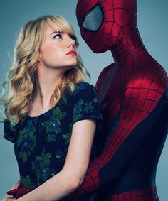 a woman standing next to a spider man