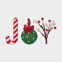 a cross stitch christmas ornament with candy canes and a bauble