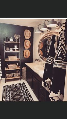 a black and white rug in a bathroom next to a sink with a mirror above it