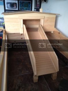 an empty wooden bench sitting on top of a tile floor