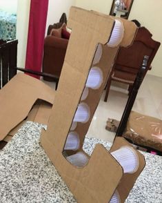 an open cardboard letter sitting on top of a counter next to a chair and table