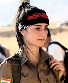 a woman in uniform with a bandana on her head