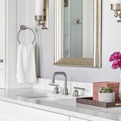 a bathroom with two sinks and a large mirror