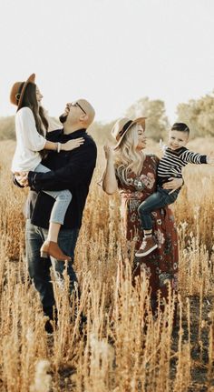 a family is standing in the middle of a field