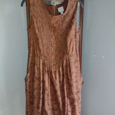 Brand Never Worn. Beautiful Design On Dress. Bodice Is Pleated. Buttons Down, Do Not Open. Zipper Down Back. Is Lined. Has Slash Pockets. Bust Is 17in Waist 16.5in Length 38in Very Flattering Dress. Brown Sleeveless Dress With Buttons, Brown Cotton Lined Dress, Brown A-line Dress With Buttons, Casual Brown Cotton Dress, Brown Pleated Summer Dress, Summer Brown Pleated Dress, Brown Sleeveless Pleated Dress, Brown A-line Daywear Dresses, Brown A-line Lined Dress